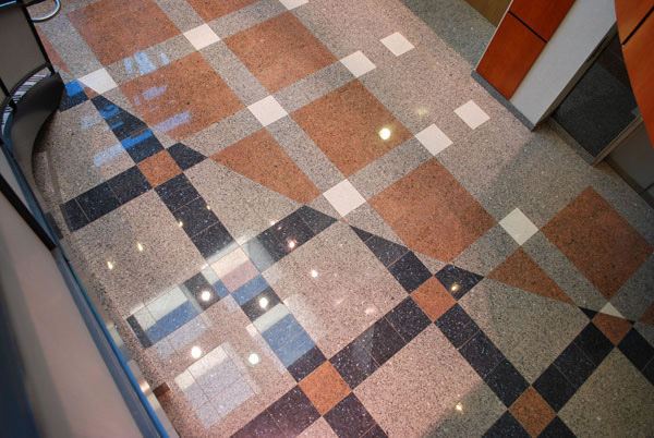 Polished patterned stone floor with red, white and black diamond inlays