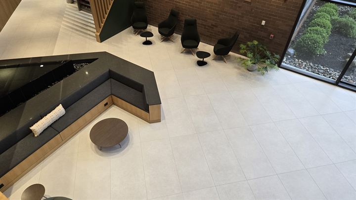 Overhead view of a lounge with built-in seating on a light large-format porcelain floor