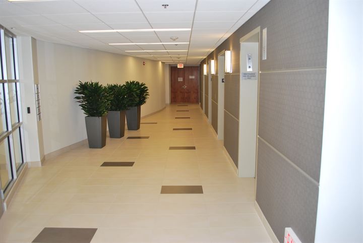 Long office corridor with an accent tile pattern down the center
